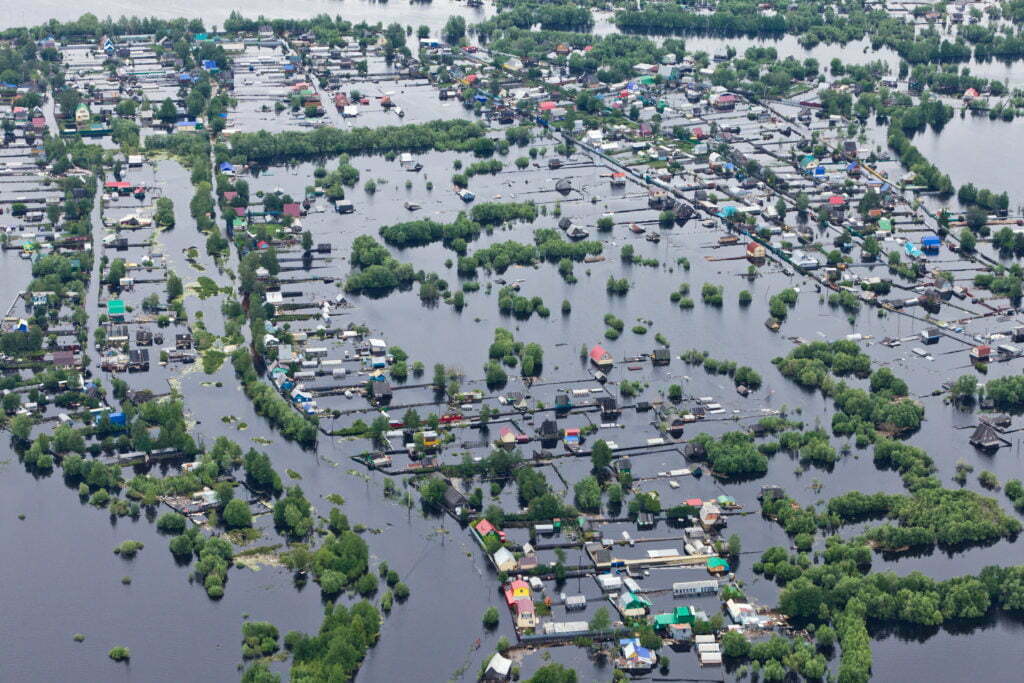An aerial view of a suburban neighborhood under water after a flood.