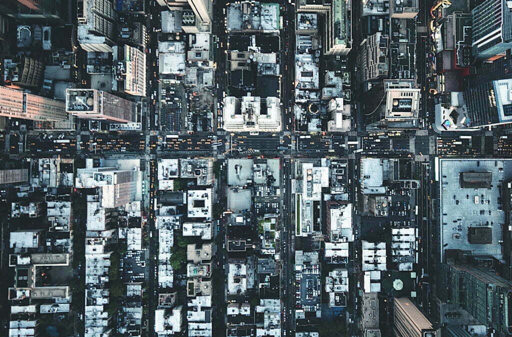 Aerial view of downtown New York City showing cars and buildings.